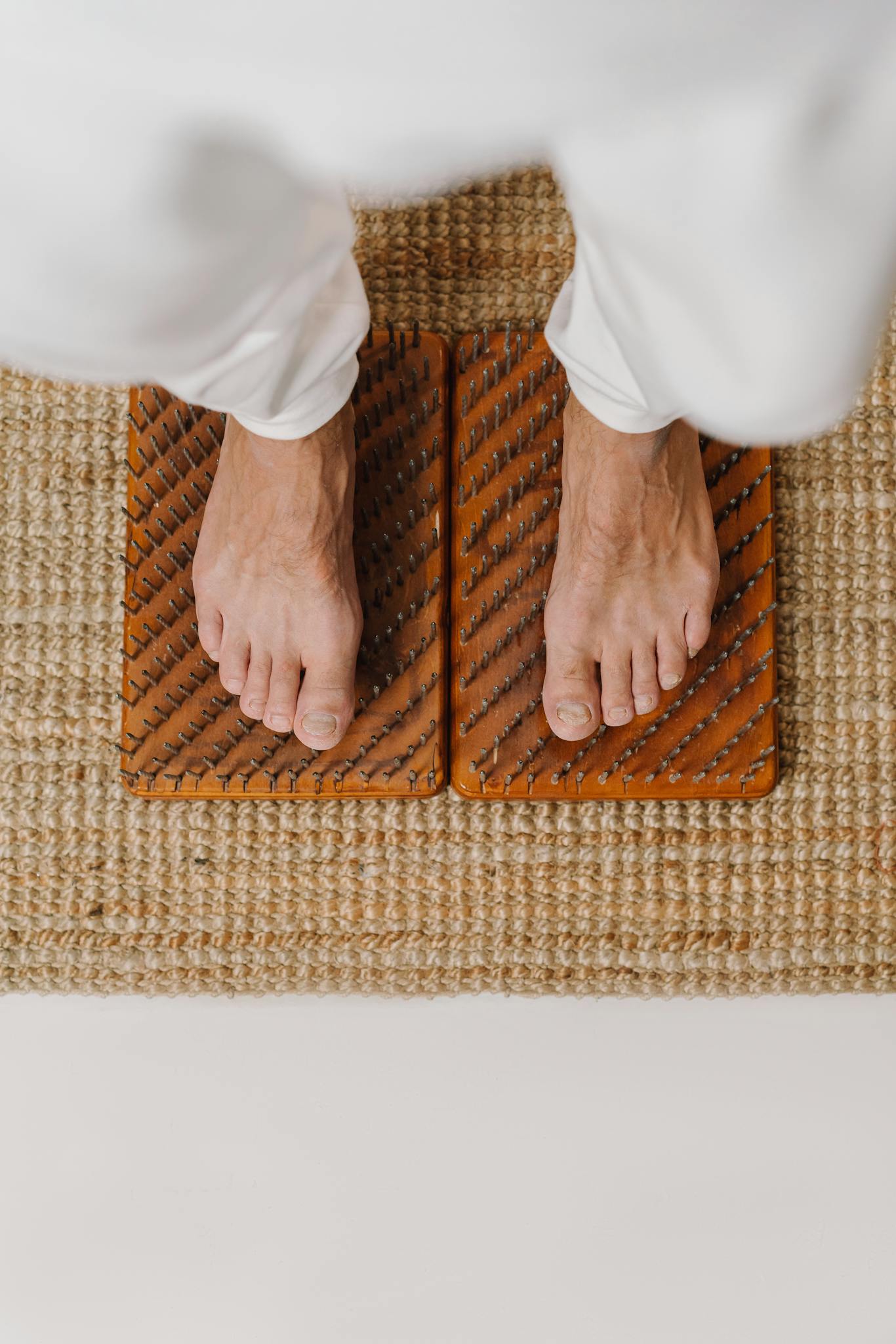 A person standing on an acupressure board for wellness and relaxation.